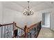 Hallway with carpet, iron railing, chandelier, and neutral walls at 15101 Sharrow Bay Ct # 12, Huntersville, NC 28078