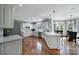 Bright and spacious kitchen with white cabinetry, stainless steel appliances, and hardwood floors at 15101 Sharrow Bay Ct # 12, Huntersville, NC 28078