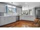 A well-lit kitchen featuring white cabinetry, modern appliances, hardwood floors and an eating area at 15101 Sharrow Bay Ct # 12, Huntersville, NC 28078