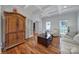 Elegant living room featuring hardwood floors, a custom cabinet, and ample natural light at 15101 Sharrow Bay Ct # 12, Huntersville, NC 28078