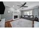 Cozy living room with a fireplace, a plush rug, and natural light flooding through the large window at 15101 Sharrow Bay Ct # 12, Huntersville, NC 28078
