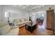 Living room featuring hardwood floors, coffered ceiling, and seamless flow to dining area at 15101 Sharrow Bay Ct # 12, Huntersville, NC 28078