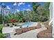 Backyard with a private pool and a lounge area, surrounded by mature trees and landscaping at 15101 Sharrow Bay Ct # 12, Huntersville, NC 28078
