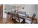 Stylish dining room with hardwood floors and decorative chandelier adding warmth at 15101 Sharrow Bay Ct # 12, Huntersville, NC 28078