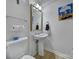 Small bathroom featuring a pedestal sink, toilet, and clean design at 15101 Sharrow Bay Ct # 12, Huntersville, NC 28078