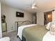 Comfortable bedroom with a ceiling fan, neutral walls, and large bed dressed in patterned linens at 1615 Merry Oaks Rd # G, Charlotte, NC 28205
