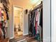 Walk-in closet with clothes hanging from a rack and a bathroom visible in the background at 1615 Merry Oaks Rd # G, Charlotte, NC 28205