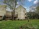 Charming multi-level townhouse featuring well-maintained lawns and private wooden balconies at 1615 Merry Oaks Rd # G, Charlotte, NC 28205