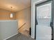 Upstairs laundry area with a modern stacked washer and dryer unit and a hanging light fixture at 1615 Merry Oaks Rd # G, Charlotte, NC 28205