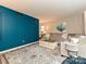 Cozy living room with blue accent wall, neutral furniture, decorative rug, and modern decor at 1615 Merry Oaks Rd # G, Charlotte, NC 28205