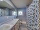 Bathroom with a decorative window, matching blue shower curtain and floor tiles at 1881 Sharonwood Ln, Rock Hill, SC 29732