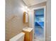 Bathroom with patterned wallpaper, a wooden mirror, and a doorway leading to another room at 1881 Sharonwood Ln, Rock Hill, SC 29732