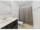 Bathroom featuring a shower with curtain, toilet, and vanity with storage at 1976 Ethan Ln, Stanfield, NC 28163