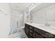Bathroom features double sinks, dark cabinetry, and a glass-enclosed shower at 1976 Ethan Ln, Stanfield, NC 28163
