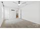 Bedroom with carpeted floors, white walls, ceiling fan, and a view of an adjacent room at 1976 Ethan Ln, Stanfield, NC 28163