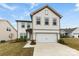 Charming two-story home featuring a pristine white facade and attached two car garage at 1976 Ethan Ln, Stanfield, NC 28163