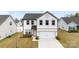 Charming two-story home features a white exterior, a two-car garage, and manicured landscaping at 1976 Ethan Ln, Stanfield, NC 28163