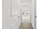 Hallway with carpet leads to a bright bedroom with windows and natural light at 1976 Ethan Ln, Stanfield, NC 28163