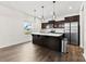 Modern kitchen with dark cabinets, stainless steel appliances, and an island with white countertop at 1976 Ethan Ln, Stanfield, NC 28163