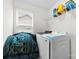 Functional laundry room with washer, dryer, shelving, and a window for natural light at 1976 Ethan Ln, Stanfield, NC 28163