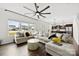 Bright living room with large sectional, modern ceiling fan, and views to the kitchen at 1976 Ethan Ln, Stanfield, NC 28163