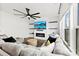 Bright living room with modern fan, television and fireplace, and lots of pillows at 1976 Ethan Ln, Stanfield, NC 28163