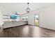 Open-concept living area with a large sectional, modern lighting, and a glass door to the yard at 1976 Ethan Ln, Stanfield, NC 28163