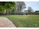 Spacious backyard with well-maintained lawn, two sheds, and surrounded by lush trees at 2064 Elizabeth Ave, Hickory, NC 28602