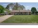 Traditional brick ranch-style home with a well-manicured lawn and a long driveway at 2064 Elizabeth Ave, Hickory, NC 28602