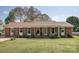 Charming brick ranch-style home with well-maintained lawn and landscaping, featuring a covered front porch at 2064 Elizabeth Ave, Hickory, NC 28602