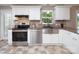 Close up of an updated kitchen featuring stainless steel appliances and white cabinets at 2064 Elizabeth Ave, Hickory, NC 28602