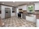 Renovated kitchen with stainless steel appliances, granite countertops, and tile backsplash at 2064 Elizabeth Ave, Hickory, NC 28602