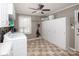 Laundry room featuring washer, dryer, storage cabinets, hanging rod, ceiling fan, and tiled flooring at 2064 Elizabeth Ave, Hickory, NC 28602