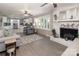 Inviting living room featuring a fireplace, large windows, and a view to the modern, updated kitchen at 2064 Elizabeth Ave, Hickory, NC 28602