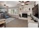 Living room with painted brick fireplace, large windows and view to the modern, updated kitchen at 2064 Elizabeth Ave, Hickory, NC 28602