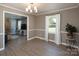 Bright living room features wood-look flooring, modern light fixture, and picture window bringing in lots of natural light at 2064 Elizabeth Ave, Hickory, NC 28602