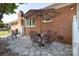 Stone patio features table and chairs beside a red brick home at 2064 Elizabeth Ave, Hickory, NC 28602