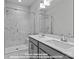 Primary bathroom featuring double sinks, modern fixtures, and a glass-enclosed walk-in shower at 212 Gilead Rd, Huntersville, NC 28078