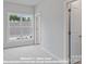 Upper level bedroom with large window offering plenty of natural light and neutral carpeting at 212 Gilead Rd, Huntersville, NC 28078