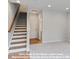 Bright entry foyer with staircase and access to lower-level flex room at 212 Gilead Rd, Huntersville, NC 28078