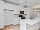 Bright kitchen featuring white cabinetry, stainless appliances, and center island at 212 Gilead Rd, Huntersville, NC 28078