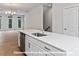 Well-appointed kitchen with stainless steel sink, quartz countertop, and white cabinetry at 212 Gilead Rd, Huntersville, NC 28078