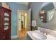 Bathroom featuring a vessel sink, vanity, mirror, and decorative storage cabinet at 2504 White Thorne Ln, Waxhaw, NC 28173
