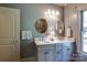 Bathroom with double sink vanity, marble countertop, mirrors, and updated fixtures at 2504 White Thorne Ln, Waxhaw, NC 28173
