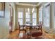 Bright breakfast nook featuring white shutters, a stylish chandelier, and an adjacent wet bar at 2504 White Thorne Ln, Waxhaw, NC 28173