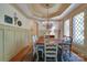 Charming dining room with decorative chandelier, large windows, and classic wainscoting with wood flooring at 2504 White Thorne Ln, Waxhaw, NC 28173
