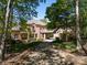 Beautiful brick home featuring a large driveway and attached garage with mature trees surrounding the property at 2504 White Thorne Ln, Waxhaw, NC 28173