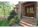 Inviting front porch with double doors, stone accents, brick steps, and professionally landscaped shrubbery at 2504 White Thorne Ln, Waxhaw, NC 28173