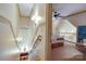 Bright hallway leading to a bedroom with a ceiling fan and a cozy loft area, showcasing the home's layout at 2504 White Thorne Ln, Waxhaw, NC 28173