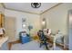 Bright and functional home office with a comfortable chair and sewing machine, ideal for creative projects and work at 2504 White Thorne Ln, Waxhaw, NC 28173